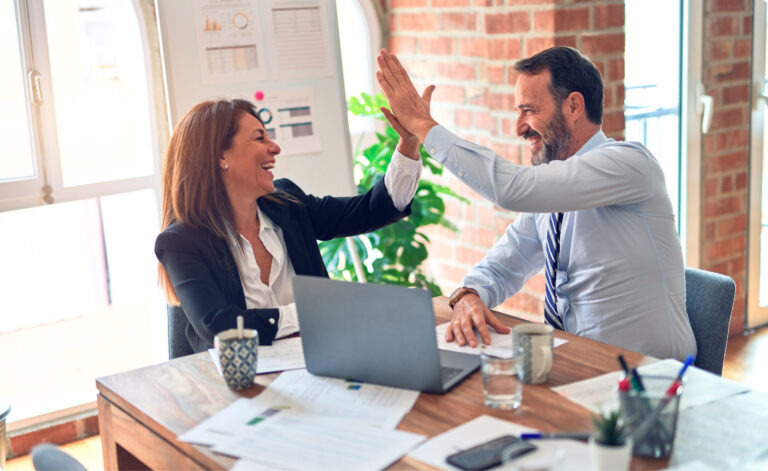 two business advisors high-fiving