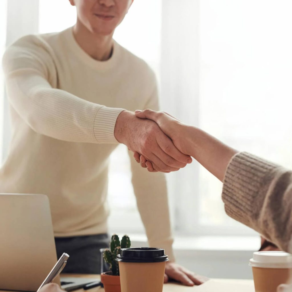 close-up of two people shaking hands